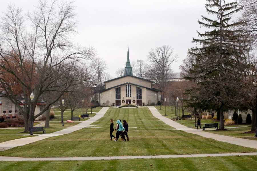 In this Dec. 9 photo, students walk on the mall at Adrian College in Adrian, Mich. The small, private Michigan college has got a deal for you: Make at least $37,000 a year after graduating or else the school will pay all or part of your loan. Adrian College has taken out an insurance policy costing about $1,100 on each student starting with this year’s freshmen. The idea is to eventually help graduates who might want to go into fields like social work, and also ease incoming students’ “sticker shock” when they see the $40,000 annual cost of the education before financial aid is factored in.