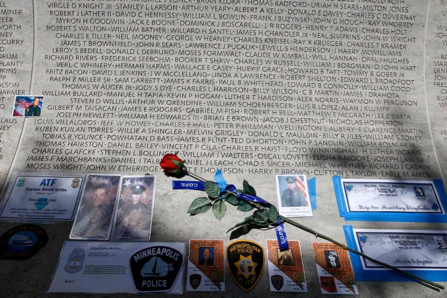 In this May 13, 2013 photo, a rose is placed at the wall with the names of fallen police officers at the National Law Enforcement Officers Memorial in Washington during the National Police Week. The number of law enforcement officers killed by firearms in the U.S. jumped by 56 percent this year and included 15 ambush assaults, according to a report released Tuesday. The annual report by the nonprofit National Law Enforcement Officers Memorial Fund found that 50 officers were killed by guns this year, compared to 32 in 2013.