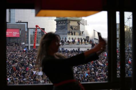 A woman takes a selfie as the crowd gathers on Bastille square, in Paris, France on Sunday. Hundreds of thousands of people marched through Paris on Sunday in a massive show of unity and defiance in the face of terrorism that killed 17 people in France's bleakest moment in half a century.