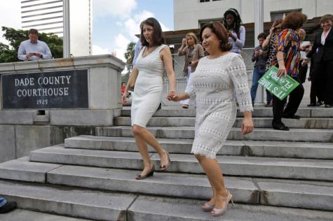 Karla Arguello, right, and Catherina Pareto, walk to the marriage license bureau after having attended a hearing in which a Miami-Dade Circuit Judge cleared the way for gay and lesbian couples to marry, Jan. 5, in Miami. 