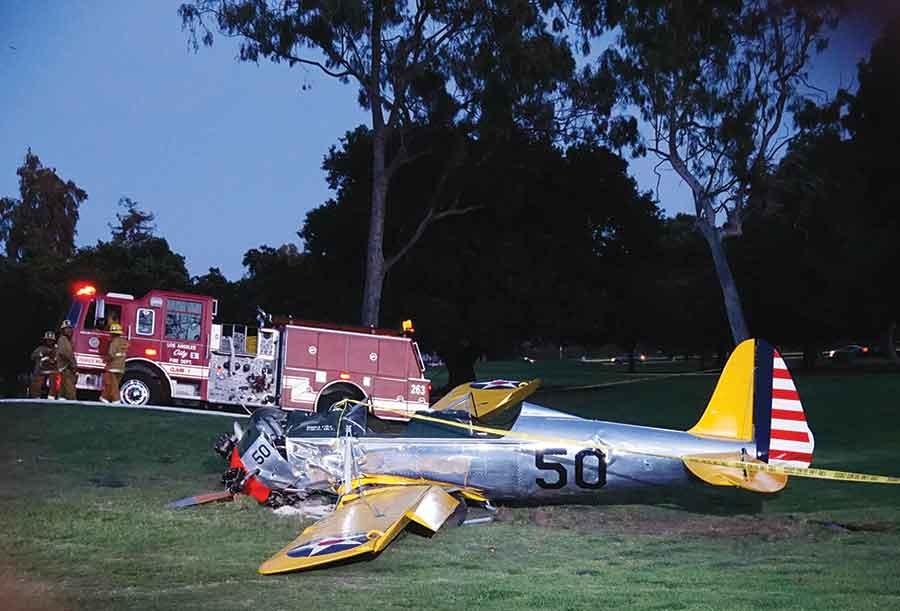 A vintage airplane that crash-landed on the Penmar Golf Course lies on the ground in the Venice area of Los Angeles, Thursday, March. Harrison Ford crash-landed the airplane shortly after taking off from a nearby airport and reporting engine problems. 