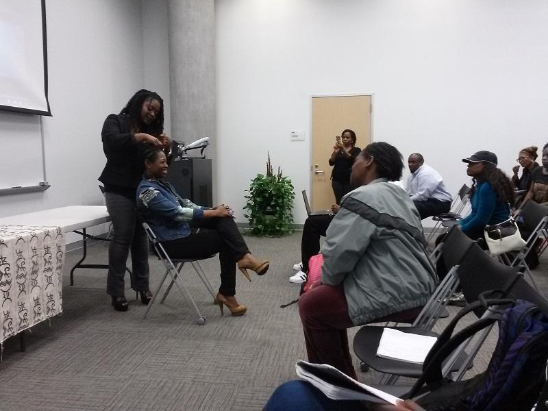 Candace Hubert, a natural hair stylist and owner of the Natural Souls Hair Cottage in Houston gives a natural hair care demonstration with a live model following the panel discussion on natural hair in honor of Womens History Month held at HCC Central March 26.