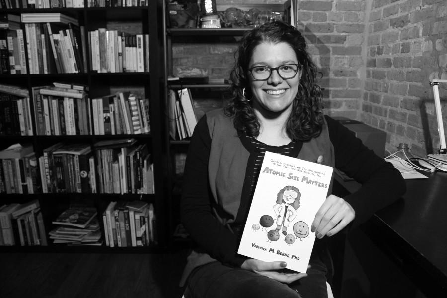 In this Feb. 5, 2015 photo, Veronica Berns holds the comic book Atomic Size Matters that she created to explain her doctoral chemistry thesis to her family at her apartment in Chicago. Berns, a comic book fan, says the illustrations are not well-polished because she wanted it to be like she was explaining on the back on an envelope. She ended up raising more than twice what she asked for on the crowd funding website Kickstarter to print the book.