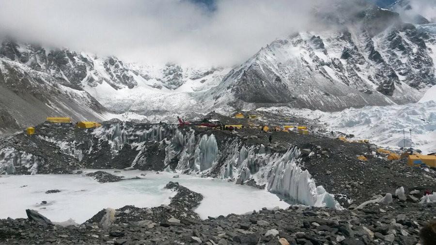 In this Monday, April 27, 2015 file photo, a rescue chopper prepares to land, evacuating climbers from higher camps to Everest Base Camp, Nepal. Despite a massive 7.8 magnitude earthquake that triggered a landslide that killed more than a dozen people, mostly Sherpa guides, at Everest base camp, government and trekking officials in Nepal said Thursday that expeditions to summit Mt. Everest may resume if climbers decide to go ahead. 