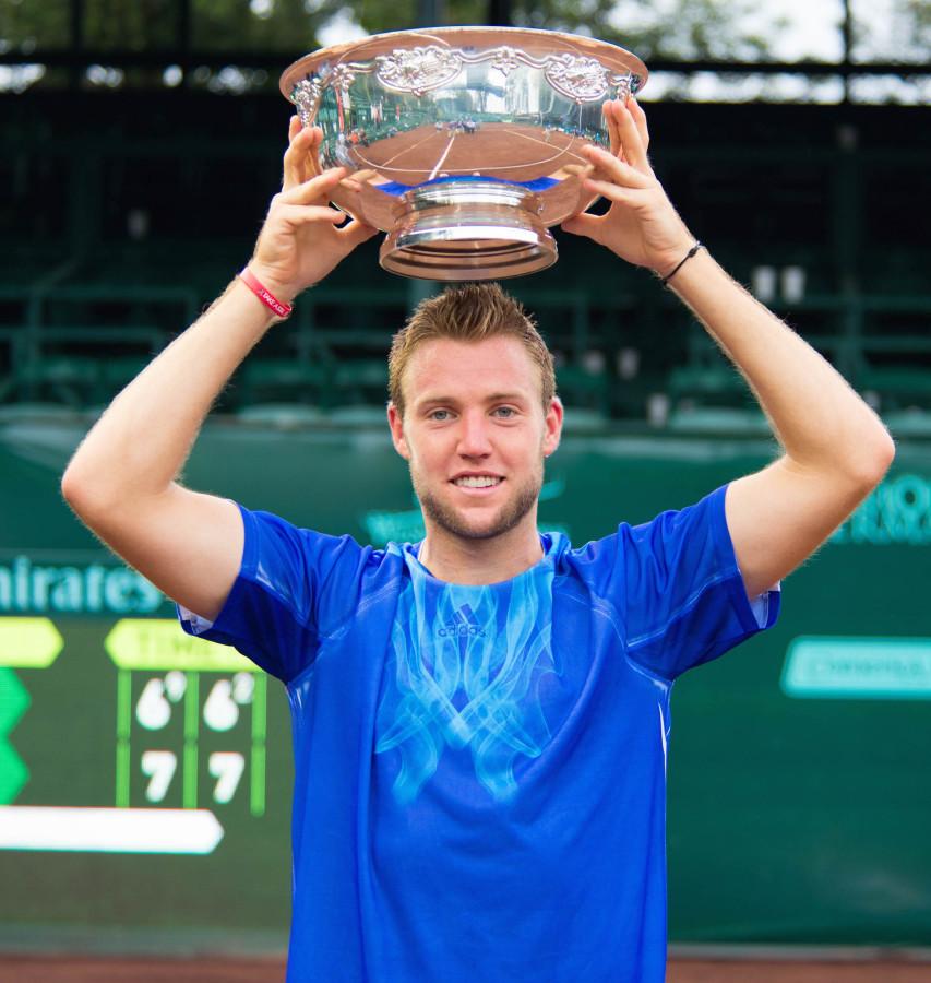 Raising+of+the+trophy+after+his+first+career+singles+victory.