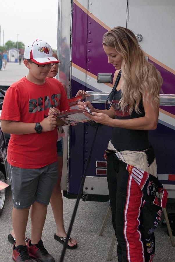 Professional drag racer Leah Pritchett signs autographs for young fans during last weeks OReilly Auto Parts NHRA SpringNationals at Royal Purple Raceway in Baytown, Texas. 
The Top Fuel racer earned her way into the first round of Sundays final eliminations before bowing out of the competition. 