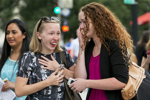 Colleen Craig of Youngstown, Ohio, left, who is bisexual and Elaine Cleary, of Chicago, who is gay, react with tears as they hear the news outside of the Supreme Court in Washington, Friday June 26, 2015, that the court declared that same-sex couples have a right to marry anywhere in the US.