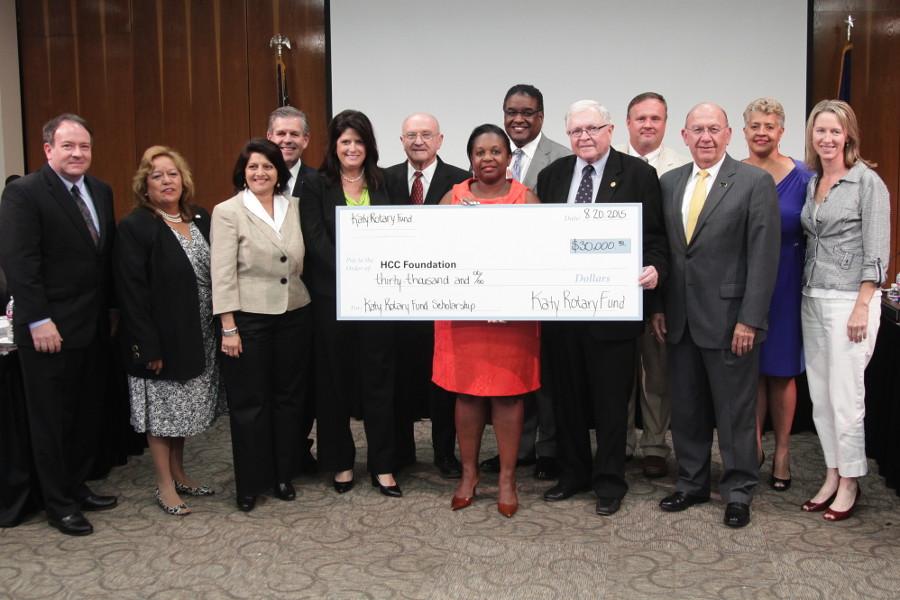 Katy Rotary Fund President Ken Burton (holding check on right) presented the organizations $30 thousand gift to The HCC Foundation at the HCC Board of Trustees meeting on Aug. 20. Here, members of the Katy Rotary stand with HCC Trustees, HCCs Chancellor and members of the HCC Foundation. 