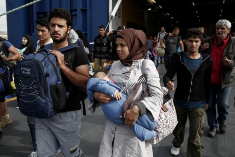 Refugees disembark from a ferry after their arrival from the northeastern Greek island of Lesbos to the Athens' port of Piraeus on Sunday, Sept. 27. 