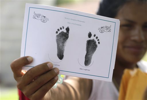 In this Sept. 16, a woman who said she entered the country illegally, shows in Sullivan City, Texas, the foot prints of her daughter who was born in the United State but was denied a birth certificate. A federal judge has chosen for now not to force Texas health officials to change their stance in denying birth certificates to immigrant families with U.S- born children, saying that the families raised grave concerns but more evidence is needed, according to a ruling issued Friday, Oct. 16. 
