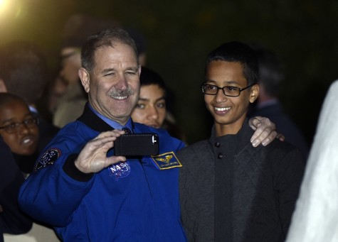John M. Grunsfeld, left, NASA's Associate Administrator for the Science Mission Directorate, takes a photo with Ahmed Mohamed, right, the Texas teenager arrested after a homemade clock he brought to school was mistaken for a bomb during the second-ever White House Astronomy Night on the South Lawn of the White House in Washington, Monday, Oct. 19. 