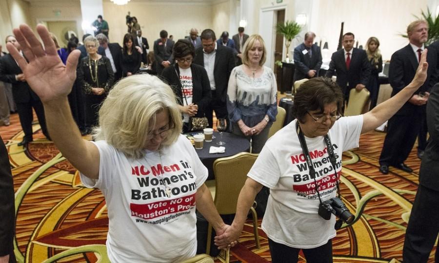 Rita Palomarez, left, and Linda Rodriguez pray during an election watch party attended by opponents of the Houston Equal Rights Ordinance on Tuesday, Nov. 3, in Houston. The ordinance that would have established nondiscrimination protections for gay and transgender people in Houston did not pass. 