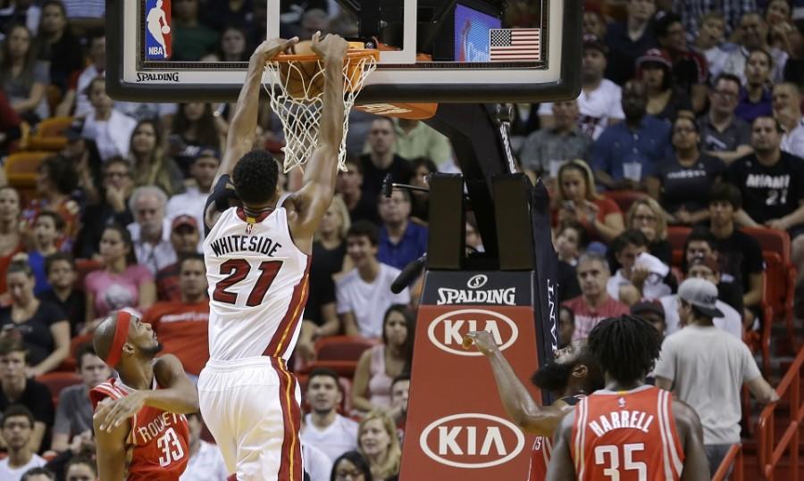 Miami Heat center Hassan Whiteside (21) dunks against the Houston Rockets in the first half of an NBA basketball game, Sunday, Nov. 1, 2015, in Miami.