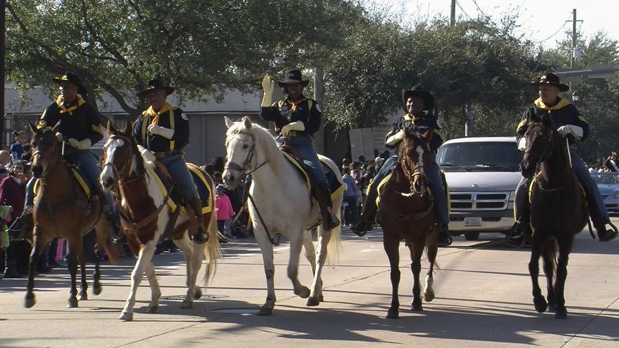 Mounted Baffalo Soldiers trot down parade route in the 2016 MLK Parade. 