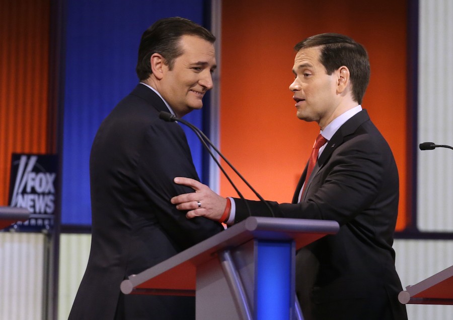 Ted Cruz and Marco Rubio talk after a Republican presidential primary debate, Thursday, Jan. 28, in Des Moines, Iowa. (AP Photo/Chris Carlson)