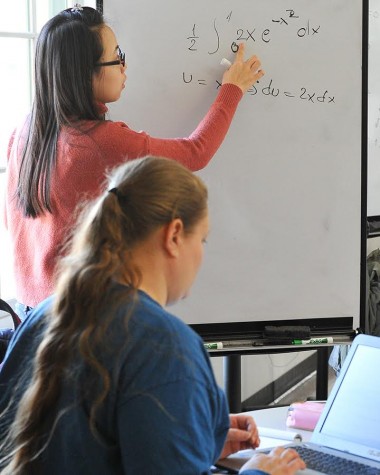 Ngo Tran tutors a student inside the Learning Emporium at HCC Central on Feb. 8. 