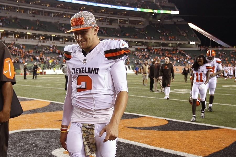 In this Nov. 5, 2015, file photo, Cleveland Browns quarterback Johnny Manziel walks off the field after the Browns lost 31-10 to the Cincinnati Bengals during an NFL football game in Cincinnati. The Browns said Tuesday, Feb. 9, 2016, that Manziel was diagnosed with a concussion late in the season by an independent neurologist, countering an NFL Network report they lied about the injury to cover up the troubled quarterback showing up intoxicated for practice.