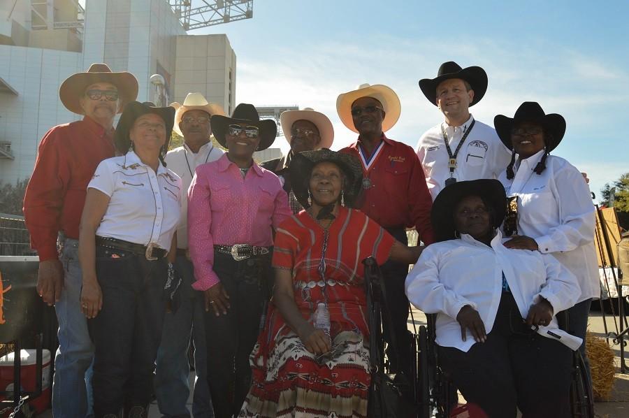 African-American cowboys pose during Black Heritage Day at the Houston Rodeo along with Rodeo President Joel Cowley. 