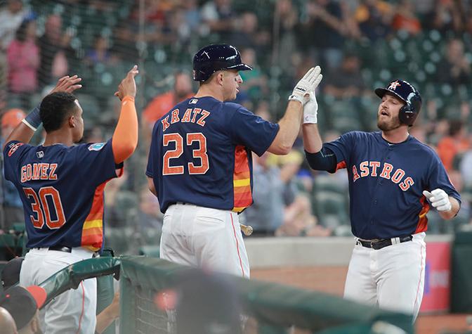 Houston Astros' Tyler White is greeted by teammates Erik Kratz and Carlos Gomez after his solo home run against the Milwaukee Brewers in the second inning of an exhibition baseball game Friday, April 1, 2016 in Houston.  