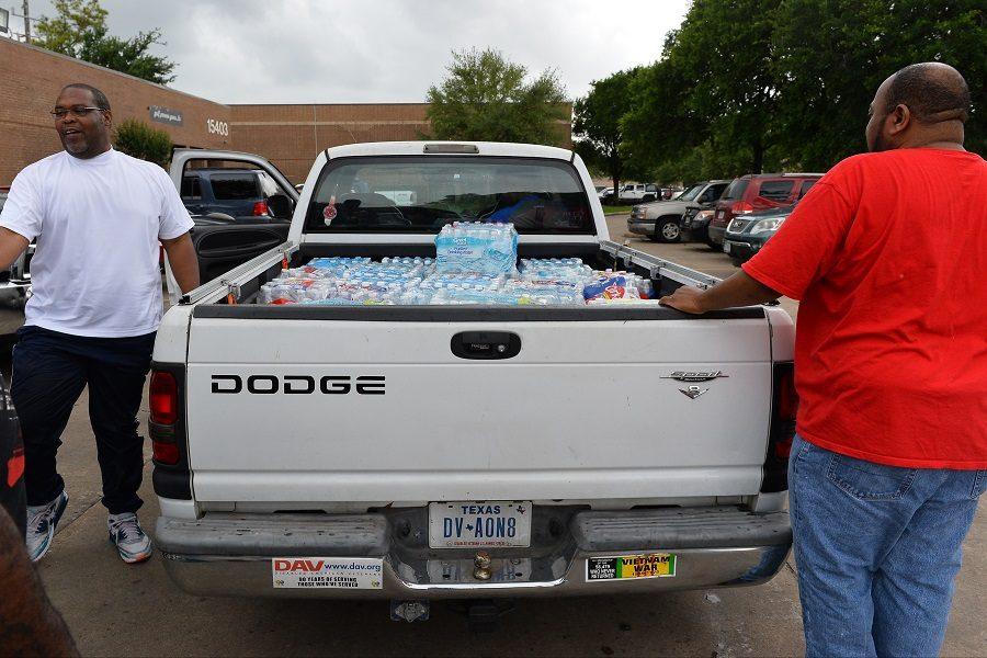 Jaye Delai delivers a truckload of bottled water collected from Third Ward residents to give to flood victims. 