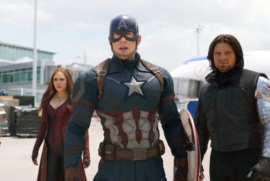 This image released by Disney shows Elizabeth Olsen, left, Chris Evans and Sebastian Stan in a scene from Marvels Captain America: Civil War, opening in theaters nationwide on May 6, 2016. (Disney/Marvel via AP)