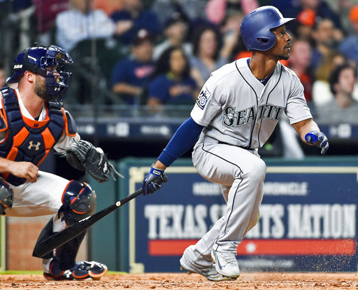 Seattle Mariners' Jarrod Dyson watches his go-ahead RBI single in the ninth inning. (AP Photo/Eric Christian Smith)