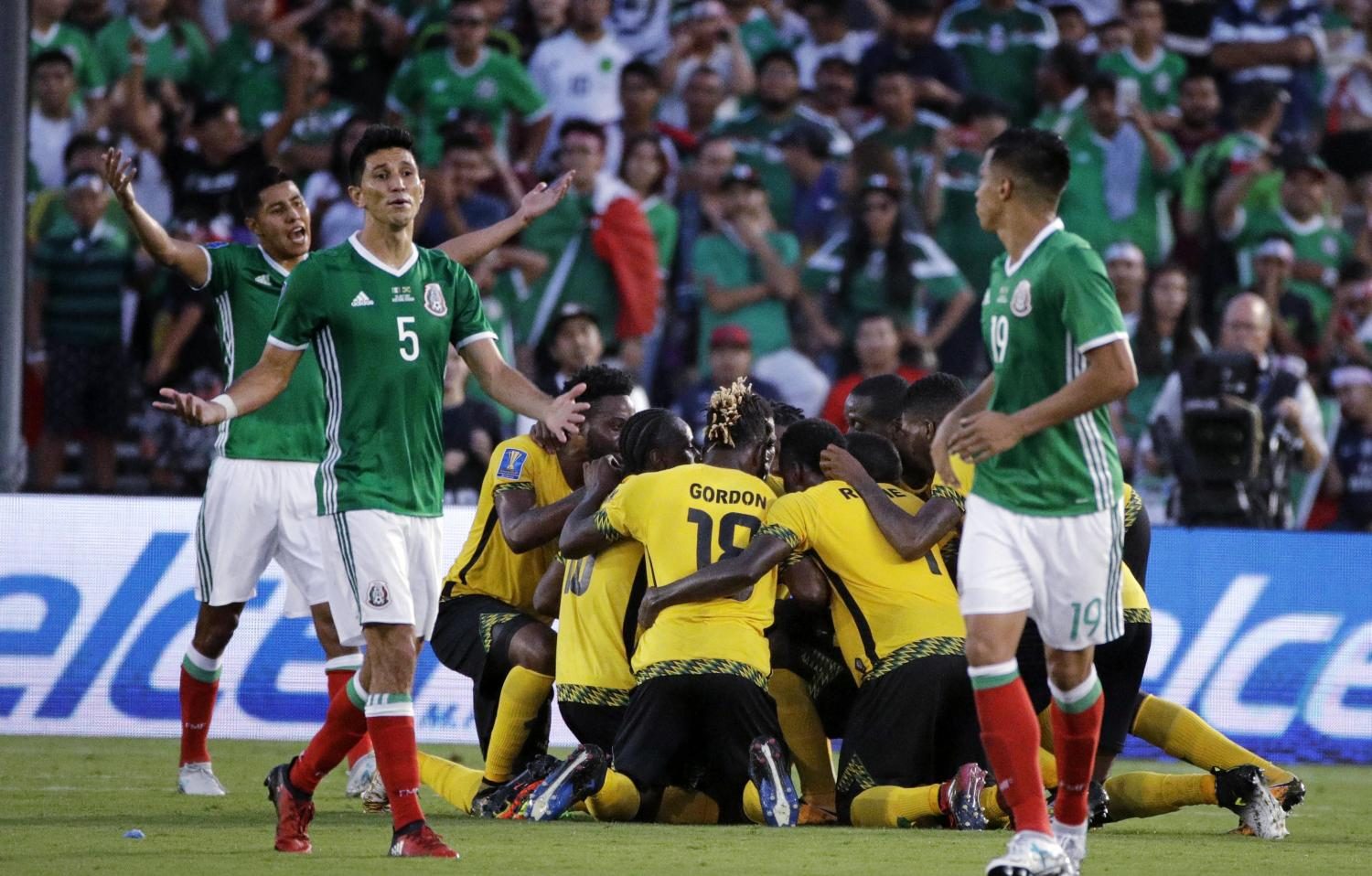 Mexico's Jesus Molina reacts as players celebrate a goal by Jamaica's Kemar Lawrence. (AP Photo/Jae Hong)