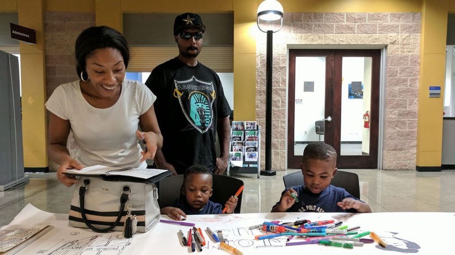 Kiara Murphy and Arindell Hodge with their sons Jerry and Jace draw at the
table.