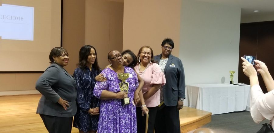 Dorothy Jenkins, first place winner of the 4th Annual Speech Tournament gets her victory picture taken alongside her granddaughter and several HCC professors and administrators, including Interim Chair of Speech & Communication Danielle Stagg.