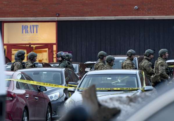 Police Officers gather outside Henry Pratt Co. after reports of an active shooter