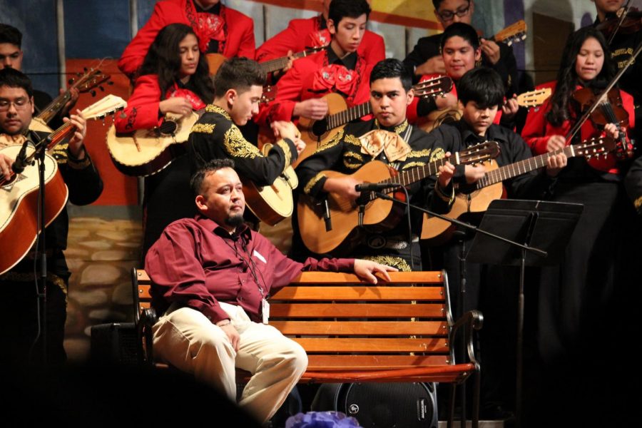 Mariachi instructor Jose Longoria sits on stage as he listens to his students perform on stage at the Sam Houston Math, Science, & Technology Center