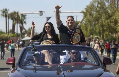 Heavyweight boxing champion Andy Ruiz Jr. and his wife, Julie, wave to a cheering crowd Saturday during a parade honoring him in his hometown of Imperial, California