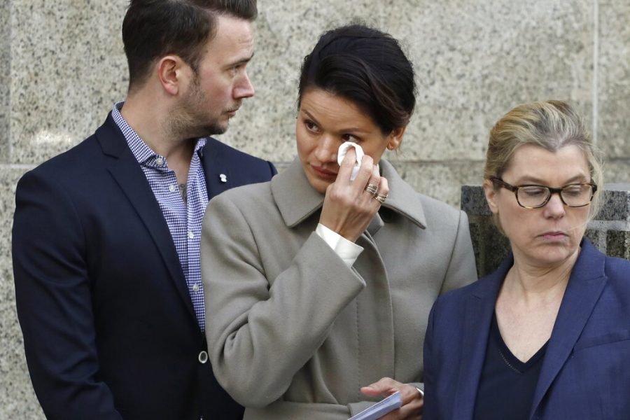 Tarale Wulff, center, wipes her eye before she speaks to the press after Harvey Weinstein's sentencing, in New York, Wednesday, March 11, 2020. Weinstein was sentenced to 23 years in prison for rape and sexual assault. During Weinstein's trial, Wulff testified that the one-time Hollywood titan raped her at his New York City apartment after luring her there in 2005 with promises of an audition for a film role.  