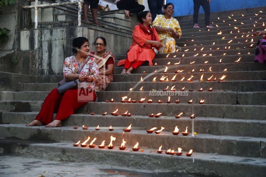 Hindu devotees light earthen lamps on the occasion of Dev Deepavali festival on the banks of Hooghly River in Kolkata, India, Friday, Nov. 19, 2021. (AP Photo/Bikas Das)
