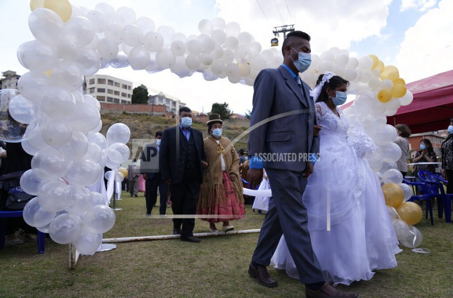 Couples take part in a procession during a mass wedding ceremony, in La Paz, Bolivia, Saturday, Nov. 6, 2021.  (AP Photo/Juan Karita)