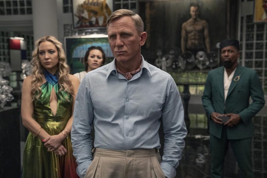 This image released by Netflix shows Kate Hudson, from left, Jessica Henwick, Daniel Craig and Leslie Odom Jr. in a scene from Glass Onion: A Knives Out Mystery. (John Wilson/Netflix via AP)