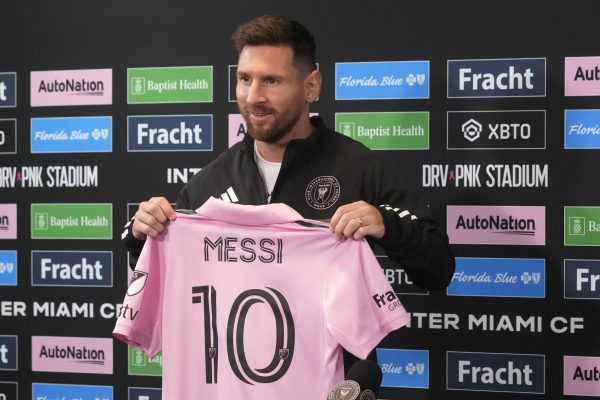 Inter Miamis Lionel Messi holds up his team jersey during a news conference, Thursday, Aug. 17, 2023, in Fort Lauderdale, Fla.