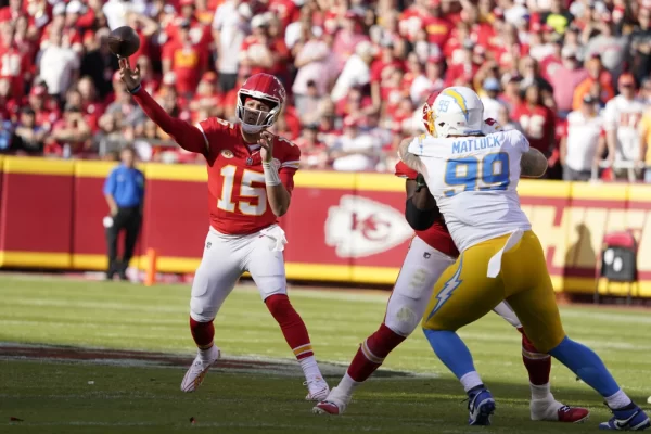 Kansas City Chiefs quarterback Patrick Mahomes (15) throws as pressure is applied by Los Angeles Chargers defender (99) Scott Matlock on October 22, 2023 in Kansas City, MO.