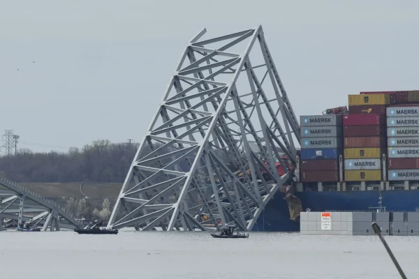 Boats move near a container ship as it rests against wreckage of the Francis Scott Key Bridge. (AP Photo/Matt Rourke)