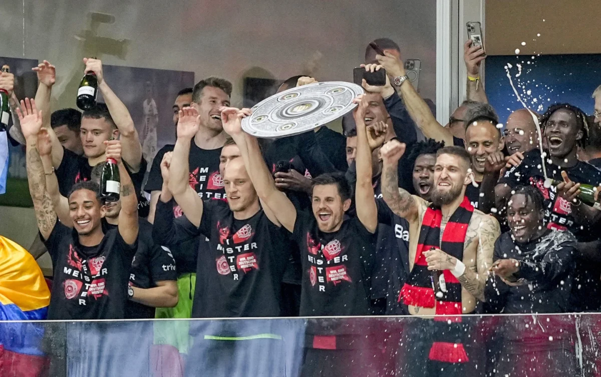 Leverkusen players celebrate with a makeshift trophy after Bayer Leverkusen won the Germany Bundesliga tittle beating Werder Bremen in Leverkusen, Germany, Sunday, April 14, 2024. 