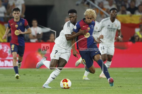 Barcelona's Lamine Yamal, right, fights for the ball with Real Madrid's Vinicius Junior during the Spanish Copa del Rey final soccer match between Barcelona and Real Madrid at Estadio de La Cartuja stadium in Seville, Spain, Saturday, April 26, 2025.