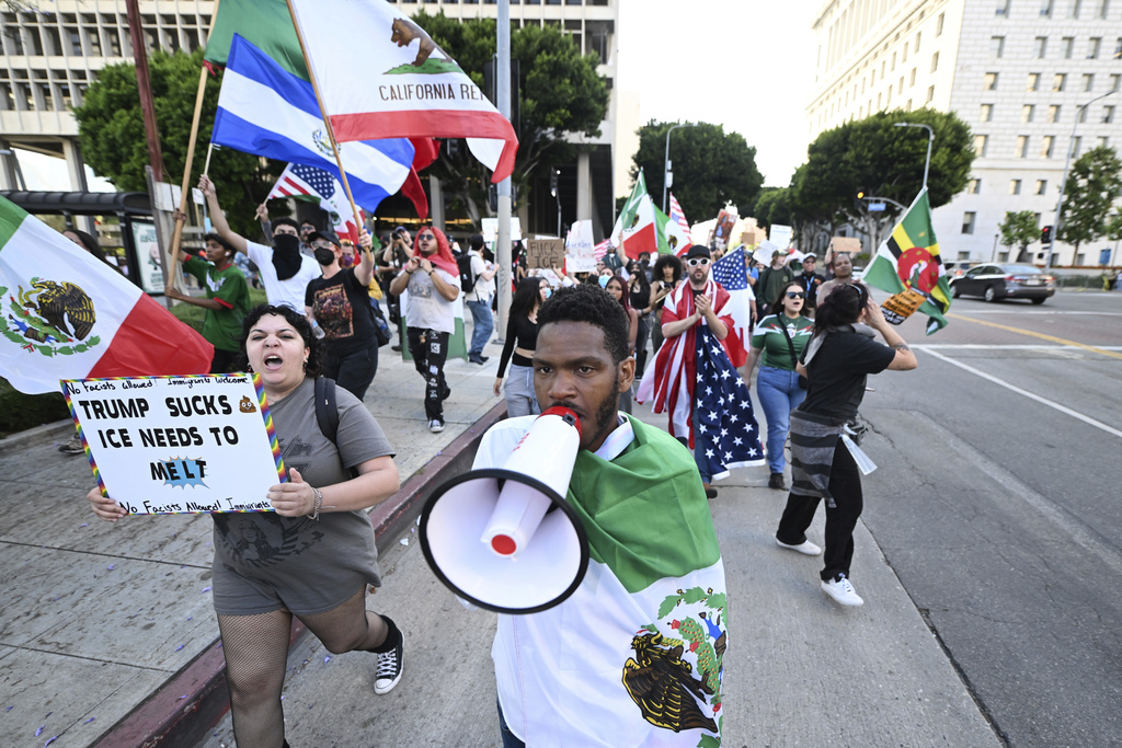 Demonstrators march in protest of recent ICE raids Thursday, June 12, 2025, in Los Angeles (AP Photo/Wally Skalij)