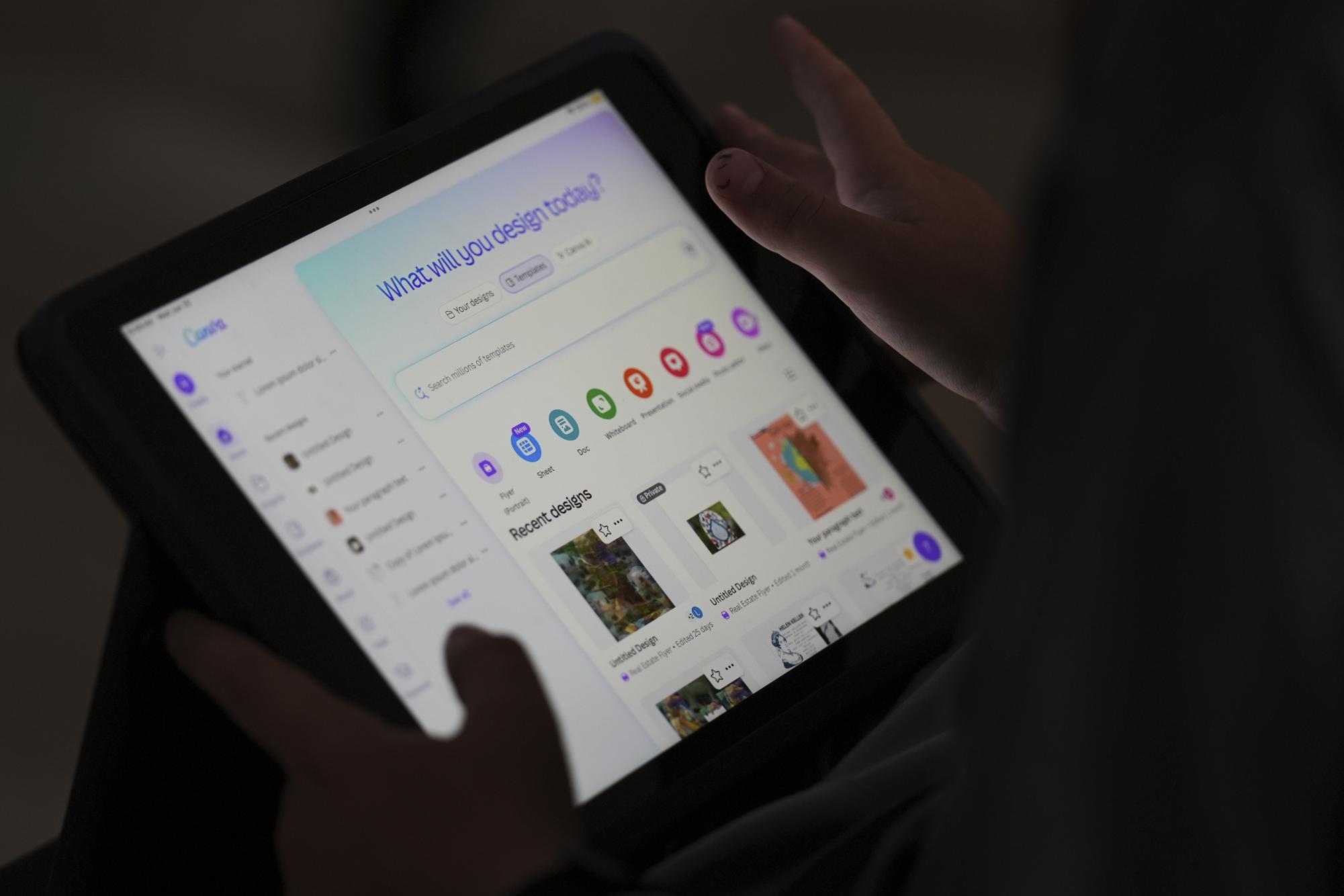 A student is taught how to ask Canva for help during a summer class at Roosevelt Middle School, Wednesday, June 25, 2025, in River Forest, Ill. (AP Photo/Nam Y. Huh)