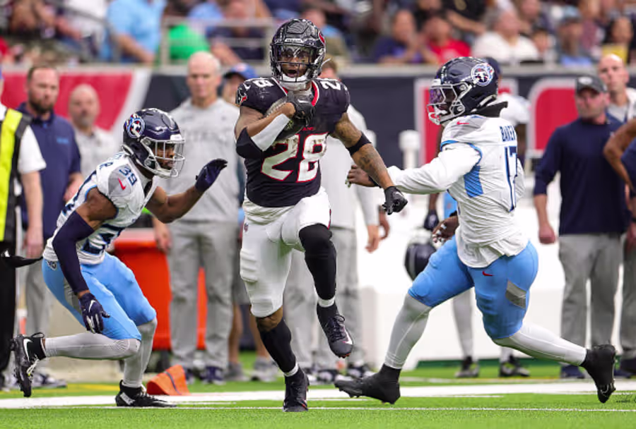 HOUSTON, TEXAS - NOVEMBER 24: Joe Mixon #28 of the Houston Texans carries the ball against the Tennessee Titans during the fourth quarter at NRG Stadium on November 24, 2024 in Houston, Texas.