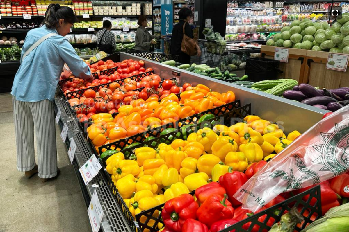 People are seen debating cost of groceries 