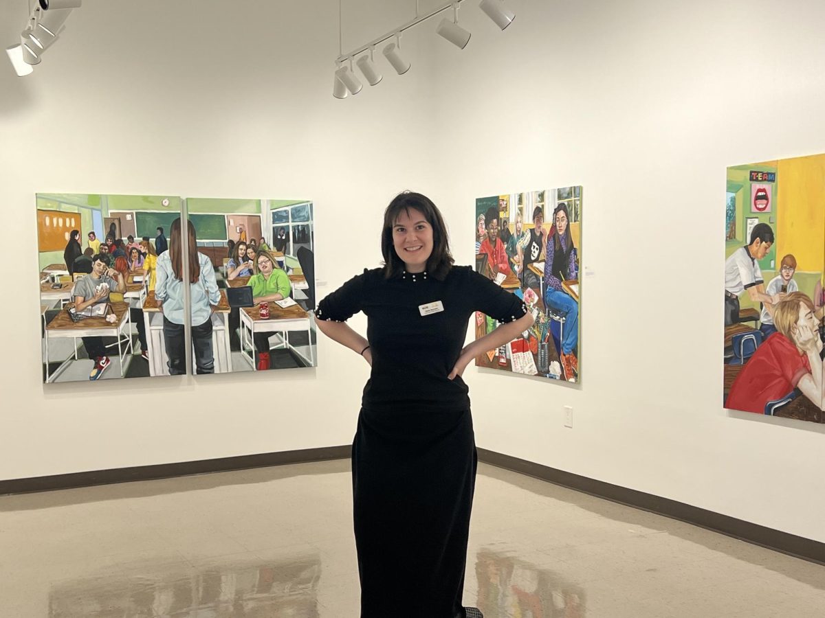 Darla Barolini posing in front of her artwork 