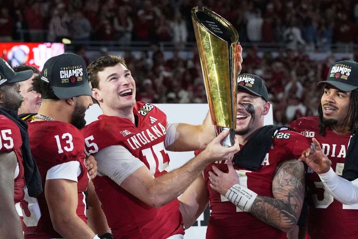 Indiana quarterback Fernando Mendoza holds the trophy after their win against Miami in the College Football Playoff national championship game, Monday, Jan. 19, 2026, in Miami Gardens, Fl. (AP Photo/Marta Lavandier)