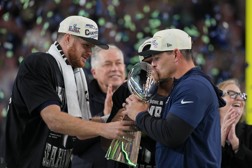 Seattle Seahawks head coach Mike Macdonald, right, and quarterback Sam Darnold celebrate with the Lombardi Trophy after a win over the New England Patriots in the NFL Super Bowl 60 football game, Sunday, Feb. 8, 2026, in Santa Clara, Calif. (AP Photo/Matt Slocum)
