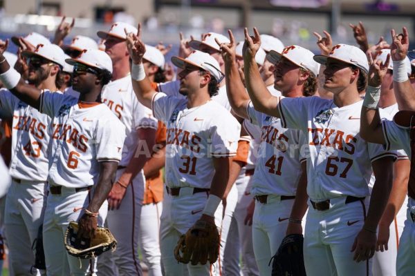 Texas teammates celebrate after an NCAA baseball College World Series elimination game against Alabama, Monday, June 15, 2026 in Omaha, Neb. Texas won 14-2. (AP Photo)