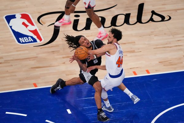 San Antonio Spurs guard Stephon Castle (5) drives past New York Knicks guard Landry Shamet (44) during Game 3 of the NBA Finals basketball series, Monday, June 8, 2026, in New York. (AP Photo/Yuki Iwamura)